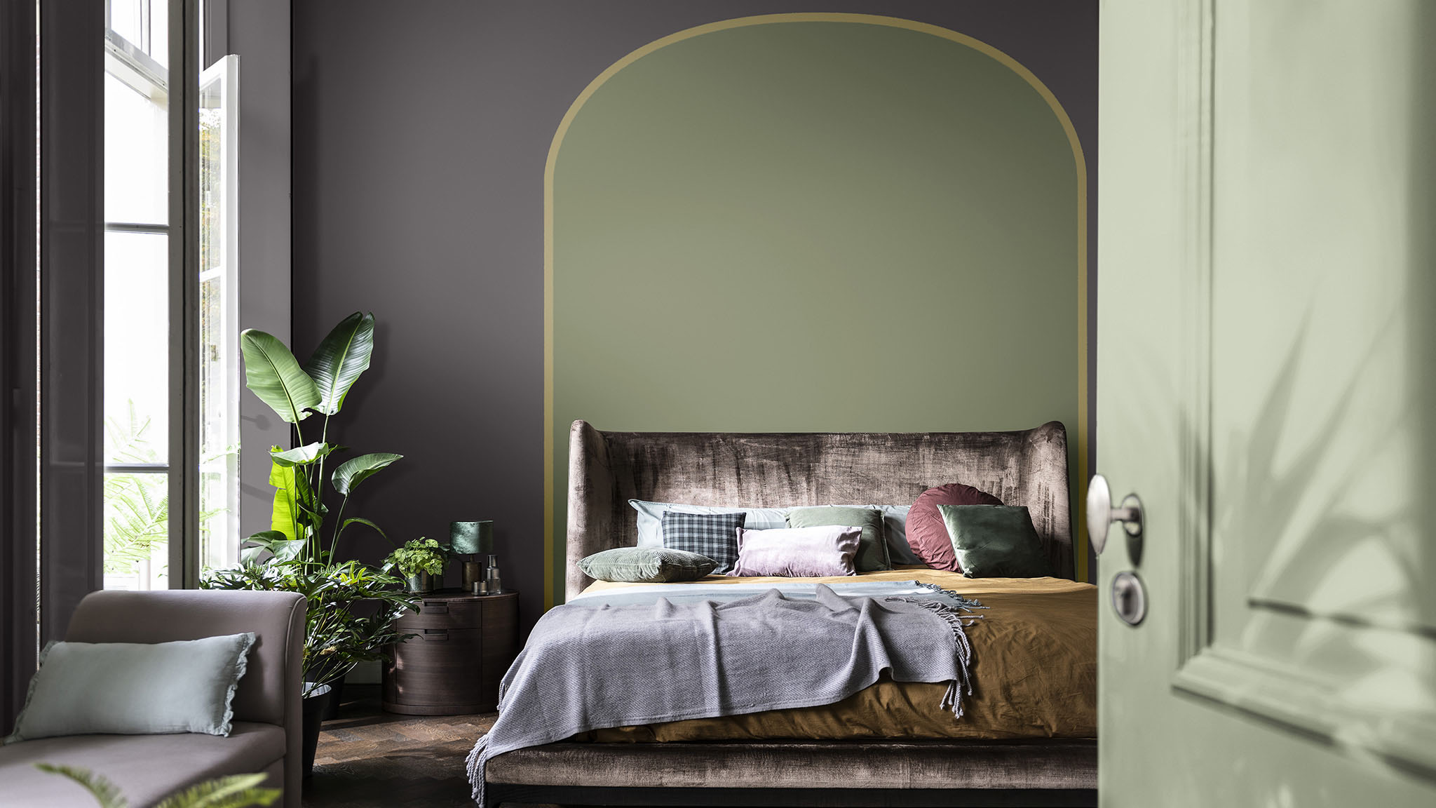 Purple walls in a bedroom with a green arch behind the bed