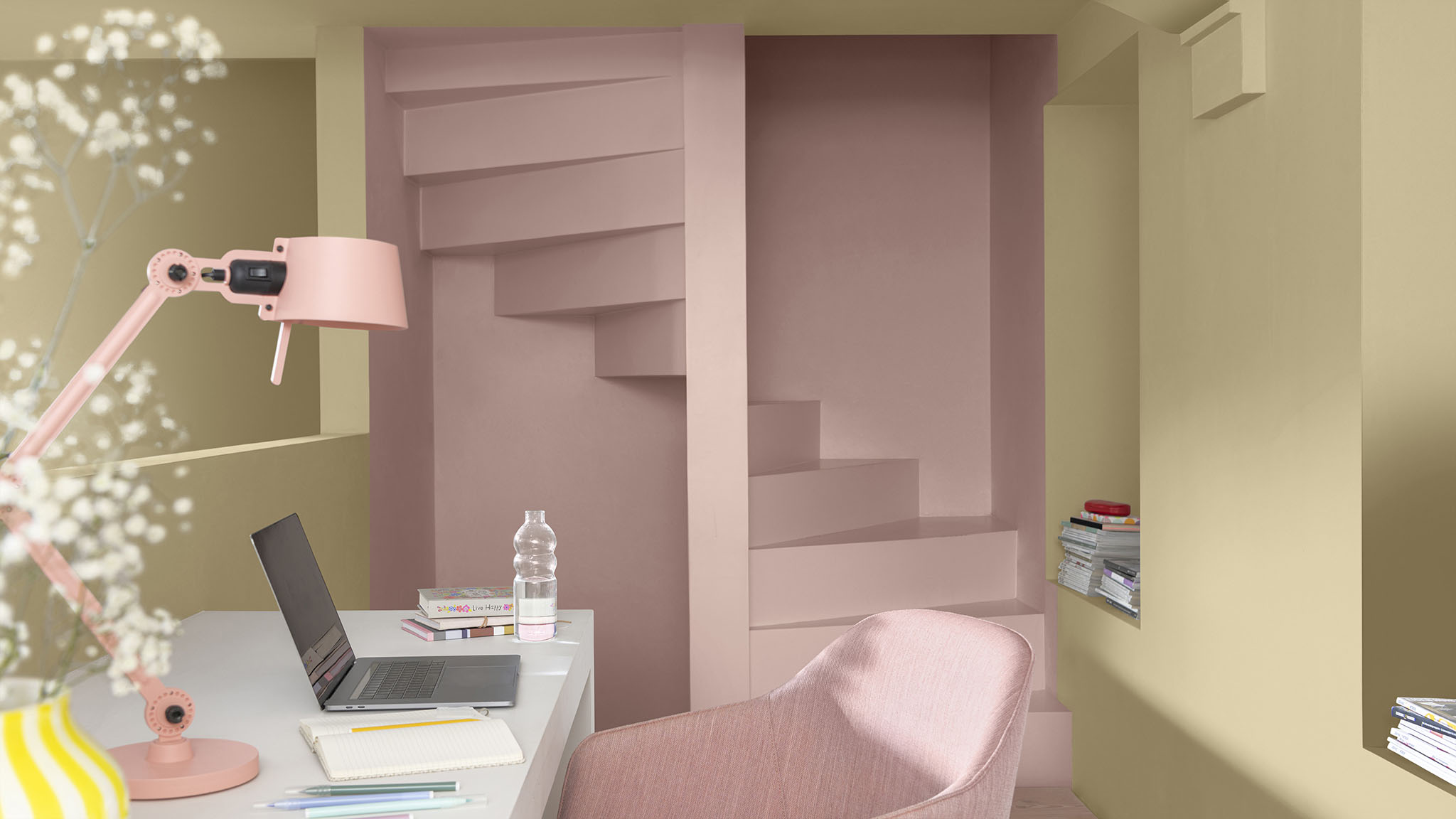 A study with a staircase painted in a pastel pink