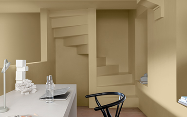 A study with a staircase painted in straw yellow 