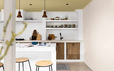 Kitchen painted in white with straw yellow ceiling