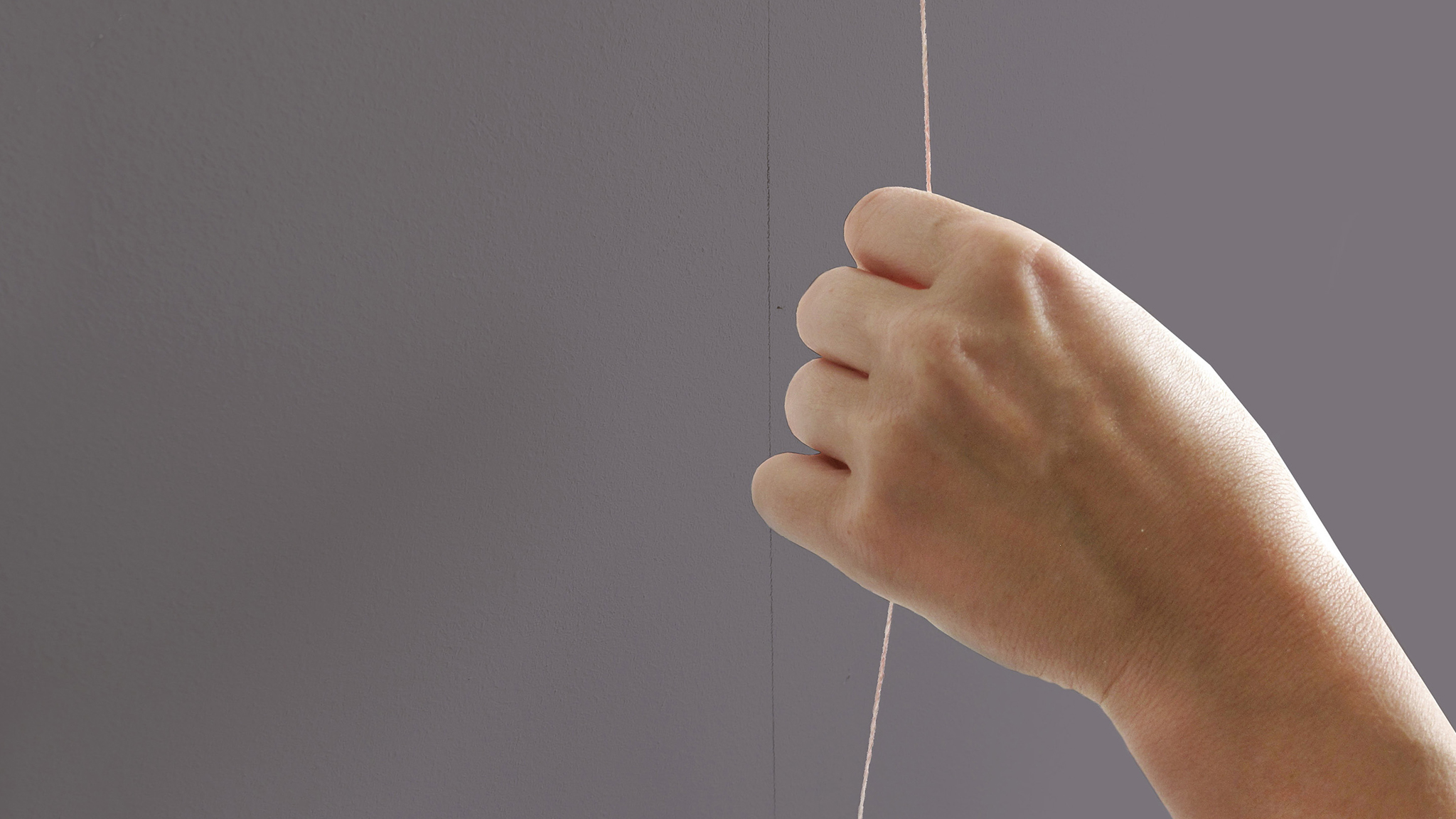 Someone pinging a chalked piece of string against a wall